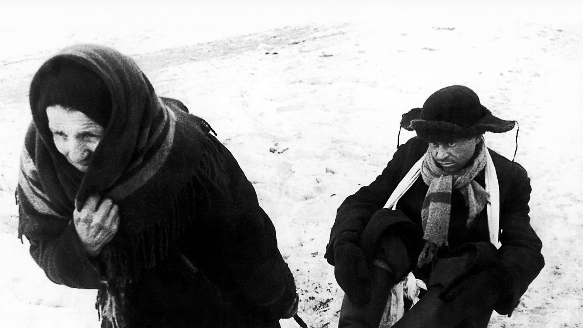 A grandmother sledging a man suffering from hunger during the Siege of Leningrad.