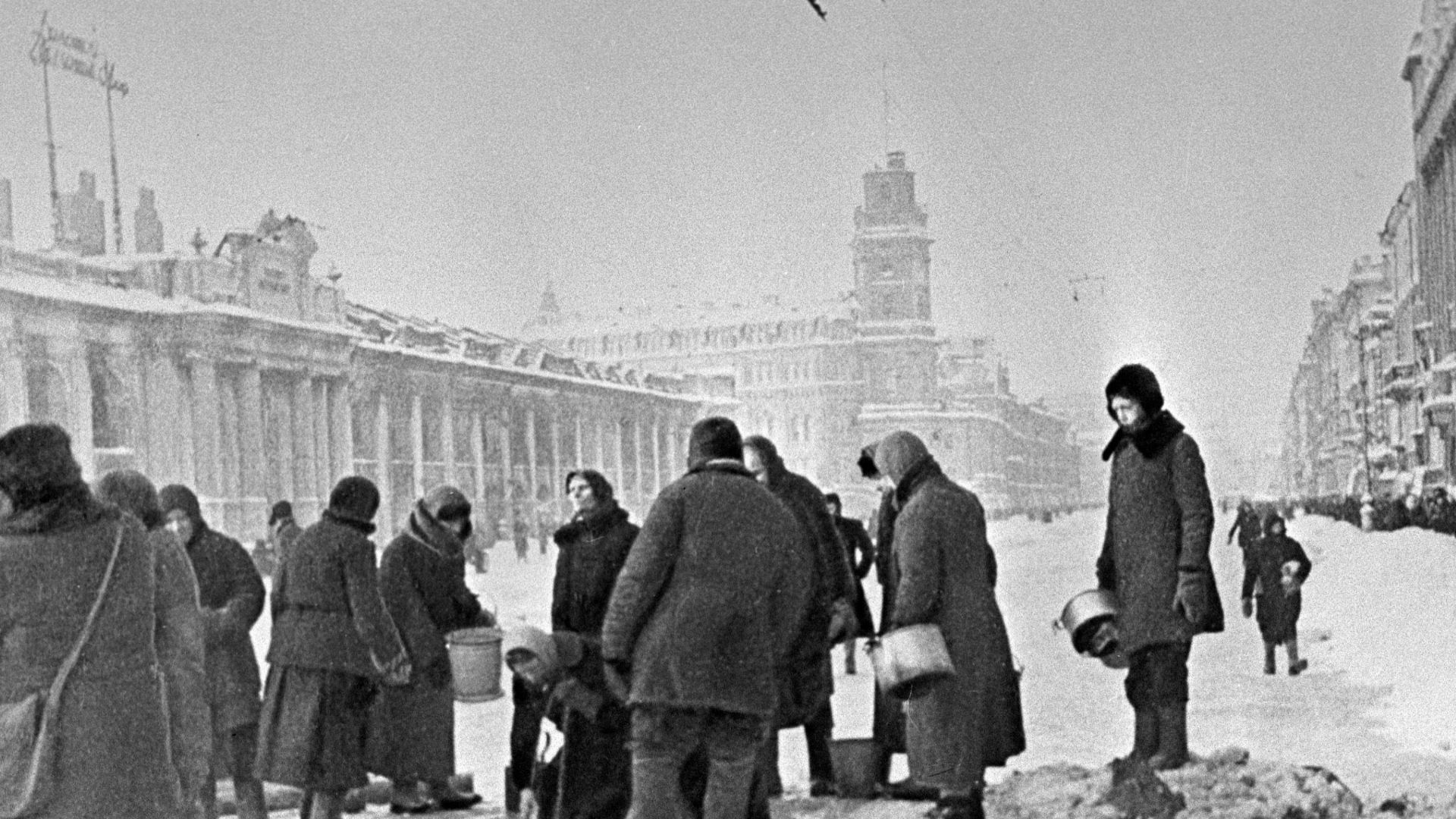 “Residents of Leningrad queueing up for water”. People in besieged Leningrad taking water from shell-holes. Location: Nevsky Prospect, between Gostiny Dvor (the long building on the left) and Ostrovsky Square.