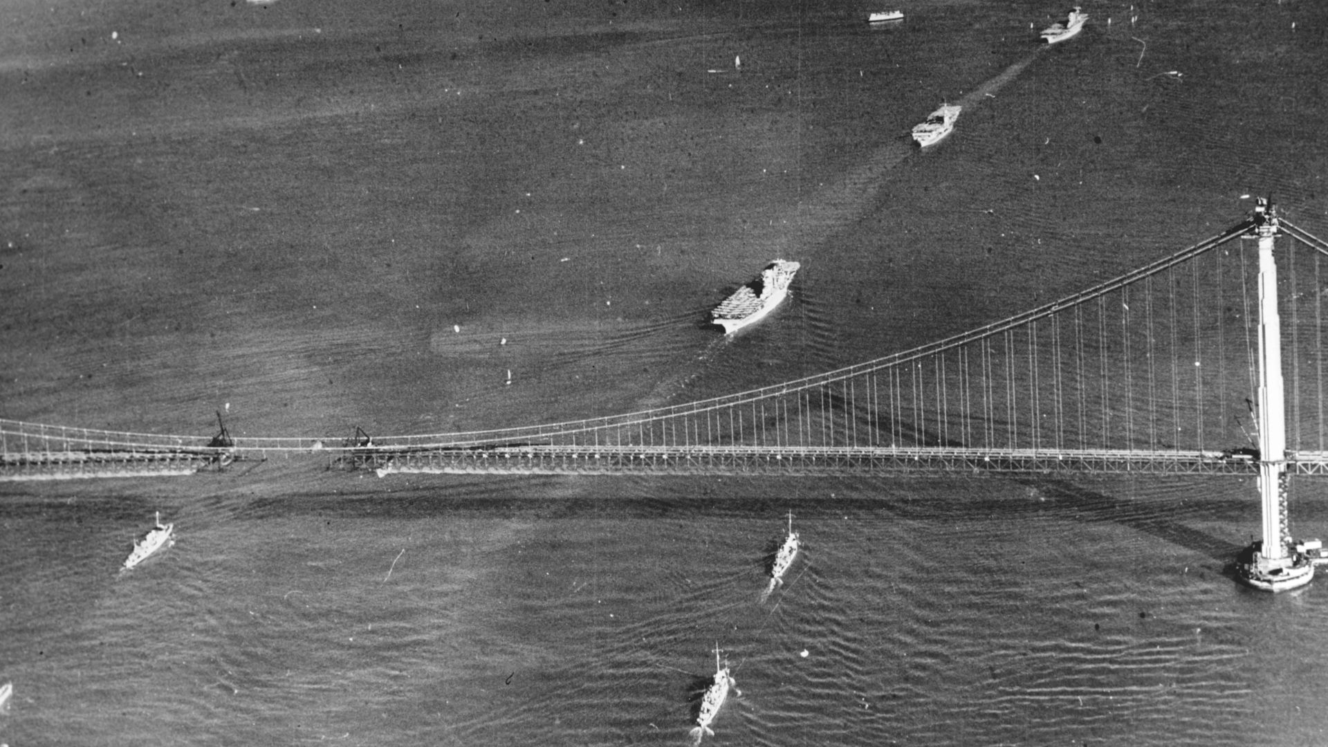 U.S. Navy ships passing under the Golden Gate Bridge, 12 November 1936, while under construction. The carriers (from front to rear) are: USS Lexington (CV-2), USS Ranger (CV-4), and the USS Saratoga (CV-3).