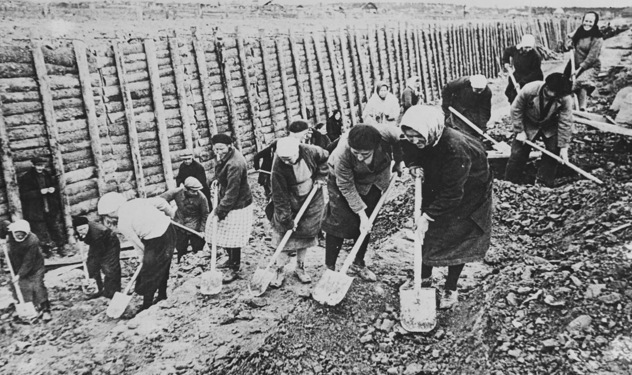 Women help dig Leningrad defenses. Russia- Leningrad inhabitants, including women of all ages, take shovels and picks to help to defend their city to the last. October 25, 1941