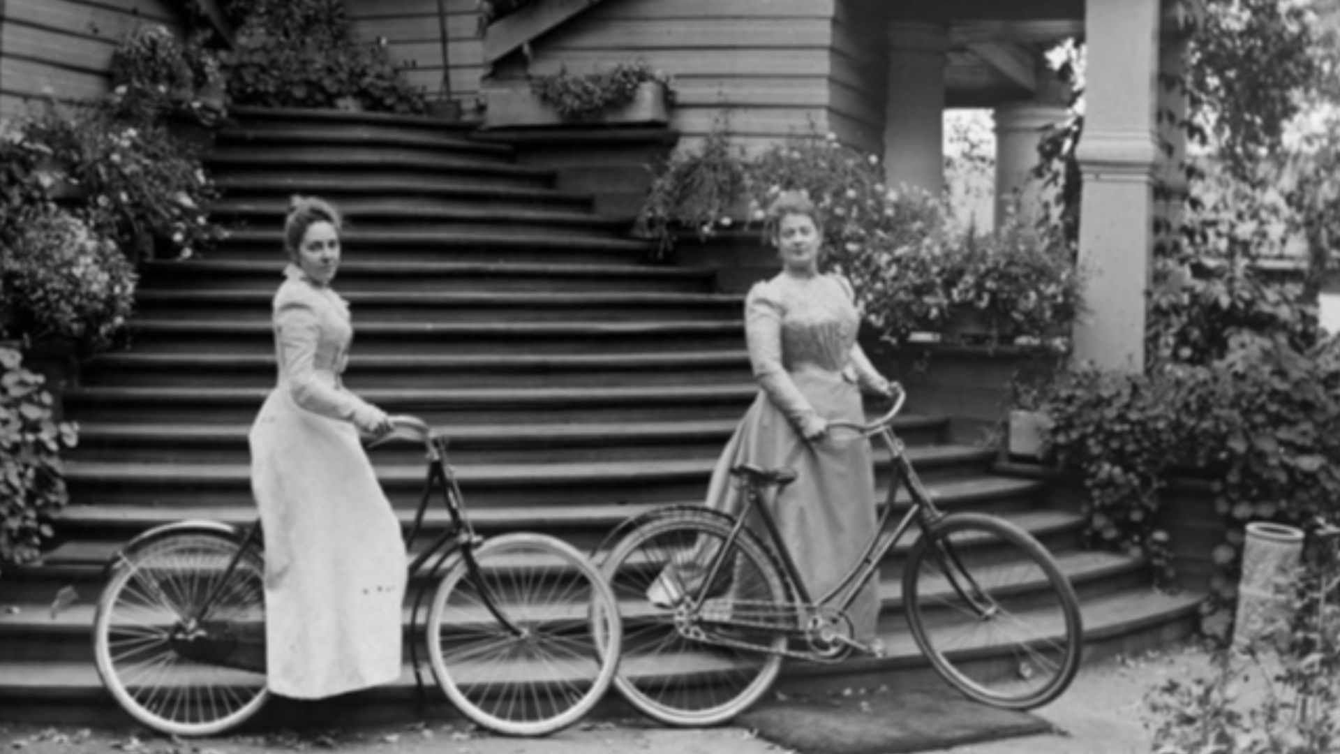 A. Mikhalkova and N. Khlebnikova with bicycles at the stairs at home in the estate Petrovskoe.