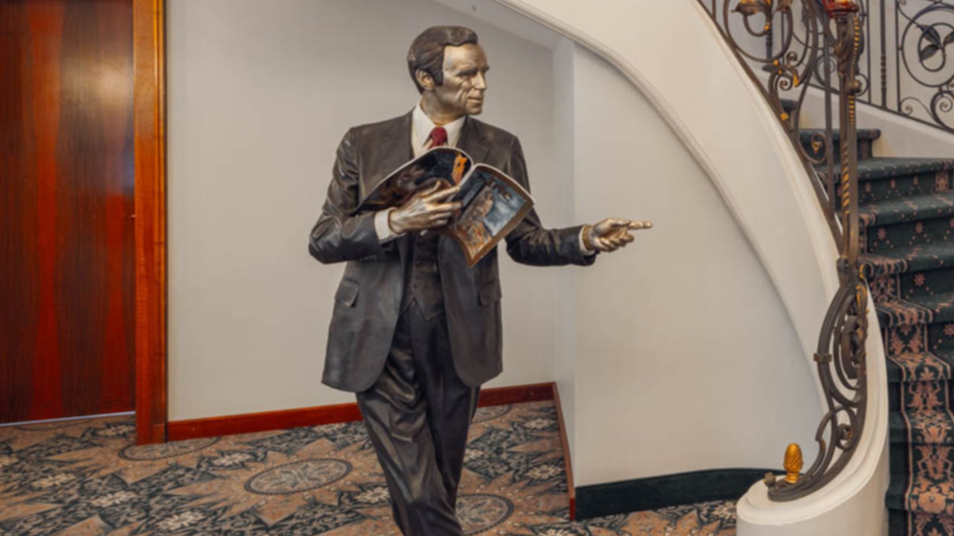 Seward Johnson II sculpture of a standing man holding a newspaper in the lobby of the luxurious hotel Le Mirador Resort & Spa located in Switzerland