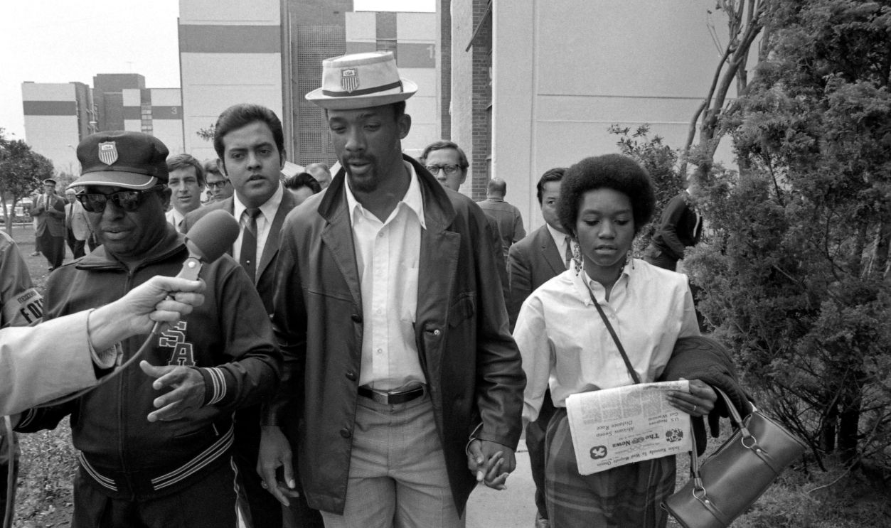 John Carlos (L) and Tommie Smith, American Black sprint stars who were ordered by the U.S. Olympic Committee to leave the Olympic Village under suspension after they staged a "black power" demonstration during Olympic award ceremonies, leave the Village together. There was speculation the ouster of Smith and Carlos might set off a mass walkout by other Blacks on the American team.