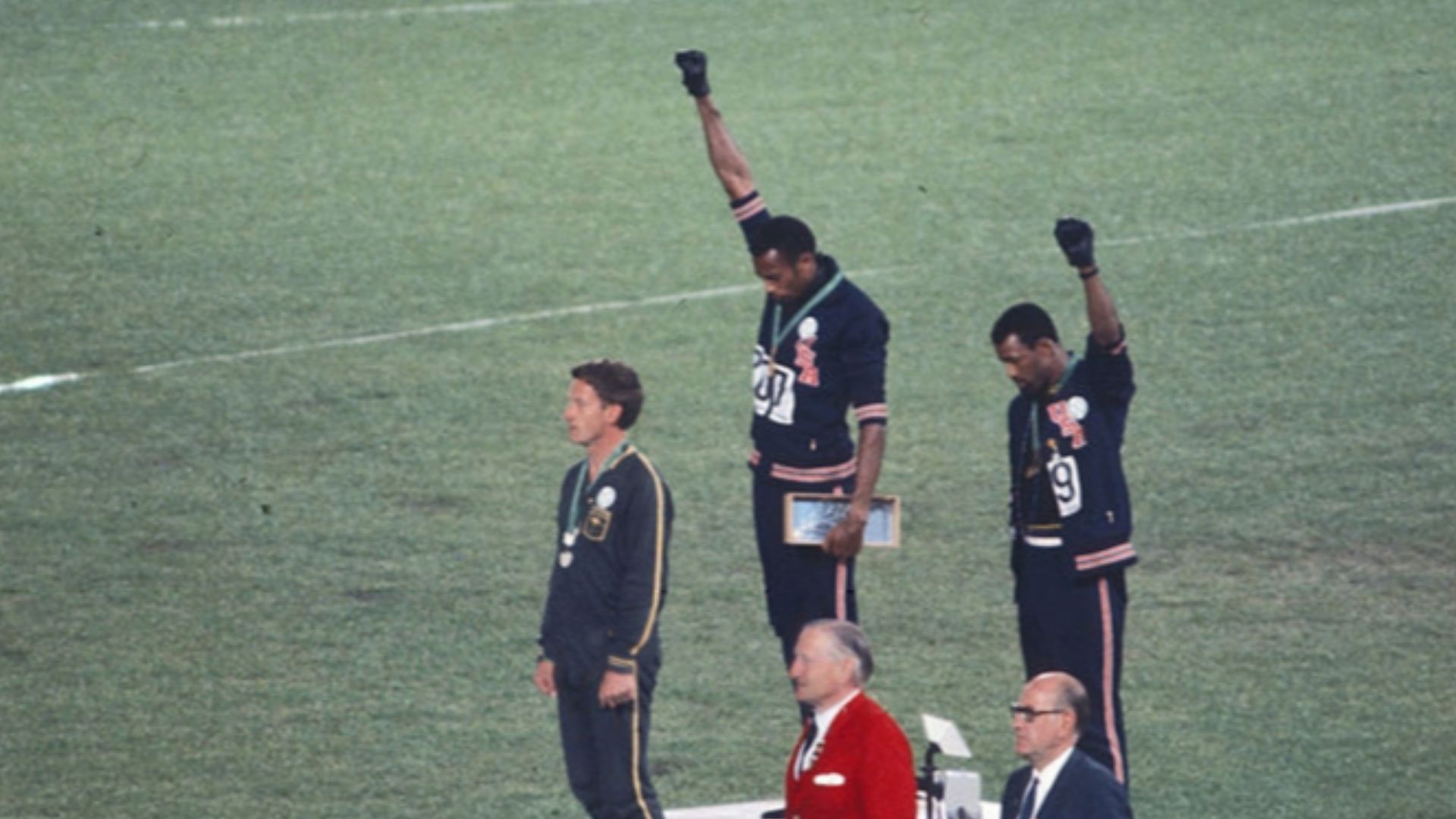 American sprinters Tommie Smith and John Carlos, along with Australian Peter Norman, during the award ceremony of the 200 m race at the Mexican Olympic games. During the awards ceremony, Smith (center) and Carlos protested against racial discrimination: t