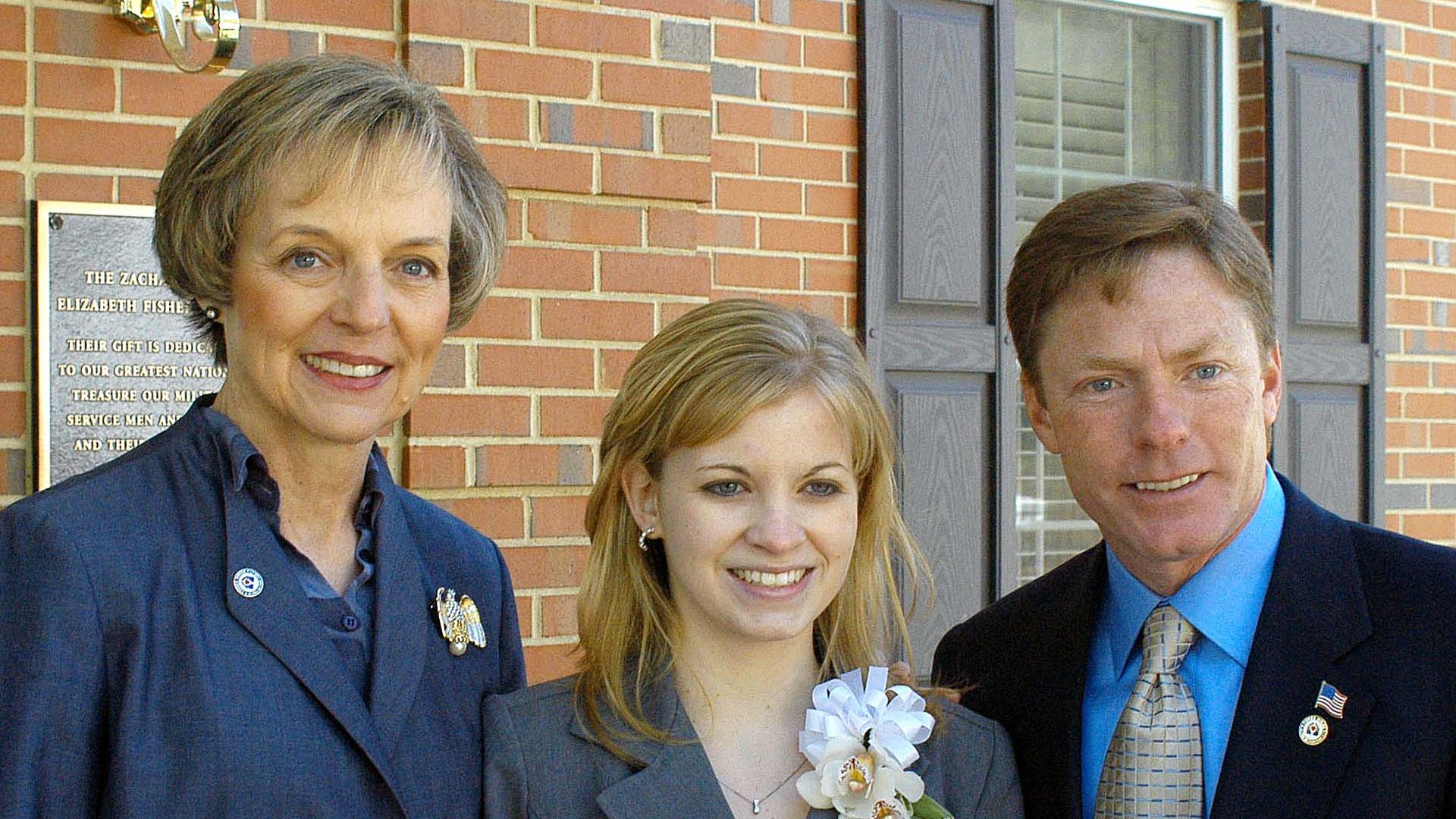 Mary Jo Myers, former Army Pfc. Jessica Lynch and Kenneth  Fisher, board chairman for the Fisher House Foundation, pose at the doorway for  the new Fisher House at Walter Reed Army Medical Center in Washington April 28.  Lynch's family stayed at Fisher Ho