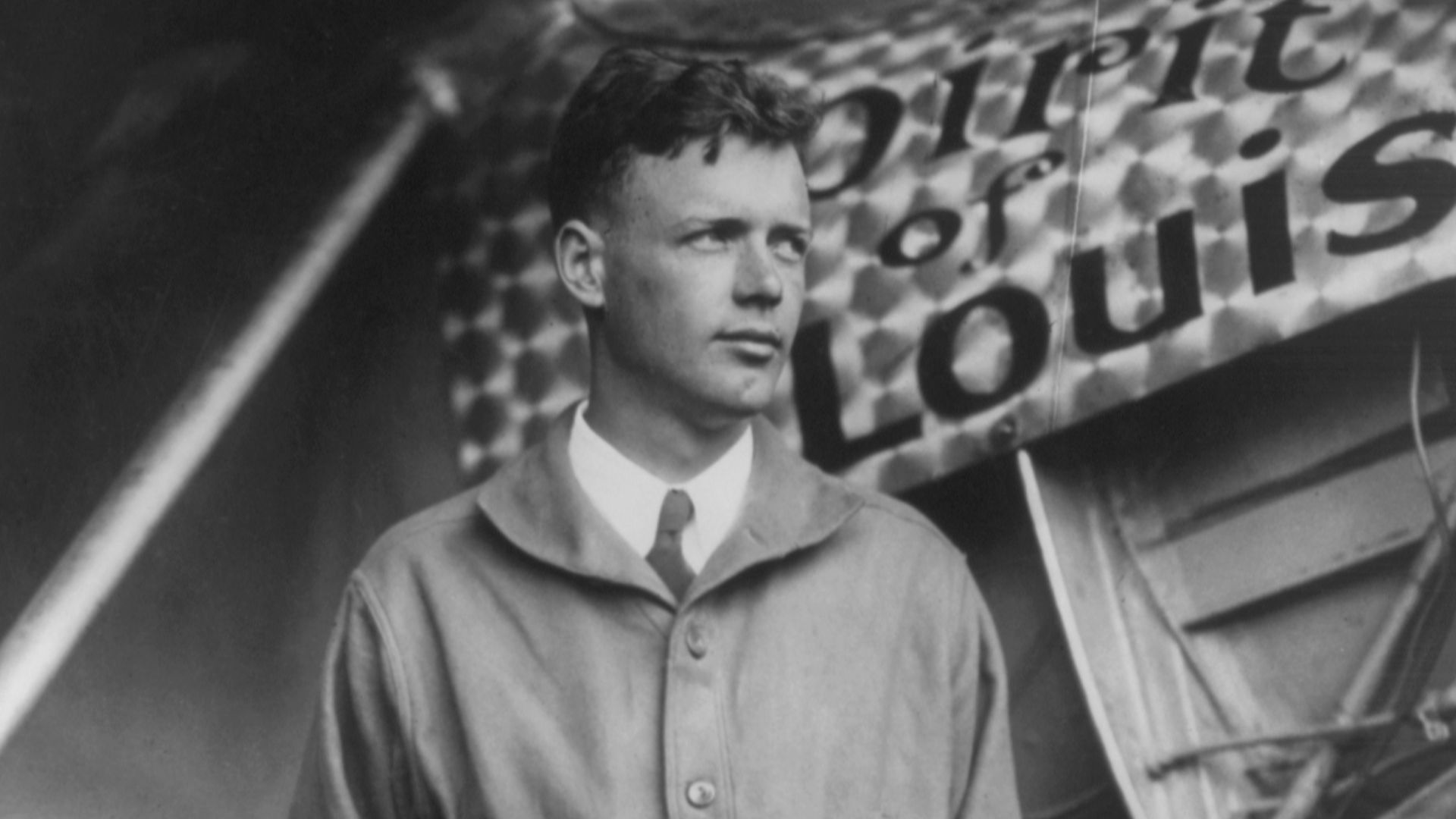Charles Lindbergh, with Spirit of St. Louis in background. Restored by Crisco 1492 from File:Charles Lindbergh and the Spirit of Saint Louis.tif (removed dust, scratches, including black spots on the wings which may or may not have been there in the origi