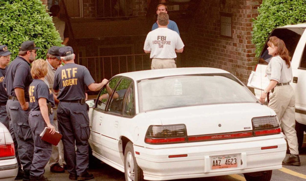 ATLANTA, GA - JULY 31: US Federal agents gather 31 July outside the home of Richard Jewell, the security guard who was working at Centennial Park at the time of the 27 July pipe bomb explosion. Federal authorities reportedly searched the apartment for evidence that might link Jewell to the bombing.