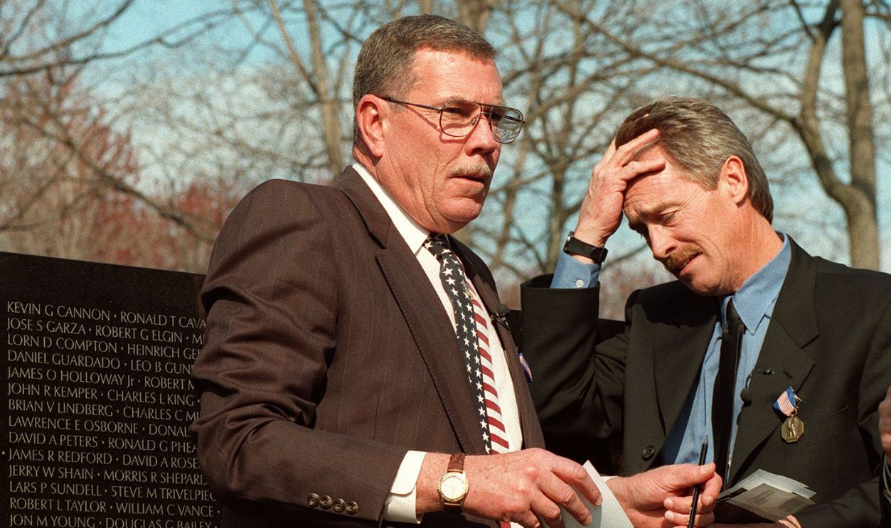 WASHINGTON, DC - MARCH 6: Former US Army warrant officer Hugh Thompson, Jr. (L) and former Army Specialist Lawrence Colburn (R) react 06 March after making a rubbing of fallen comrade Glenn Andreotta's name from the Vietnam Veterans Memorial in Washington, DC. Thompson, Colburn and Andreotta were awarded the Soldier's Medal for heroism stemming from actions taken by the three to save civilian lives during the My Lai Massacre in March of 1968 in the Quang Ngai Province, South Vietnam.