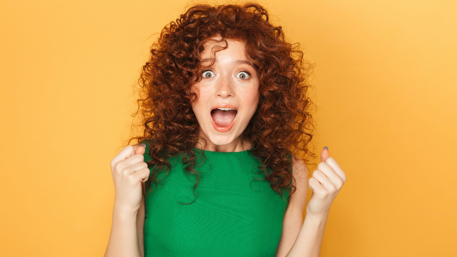a woman in a green dress making a funny face