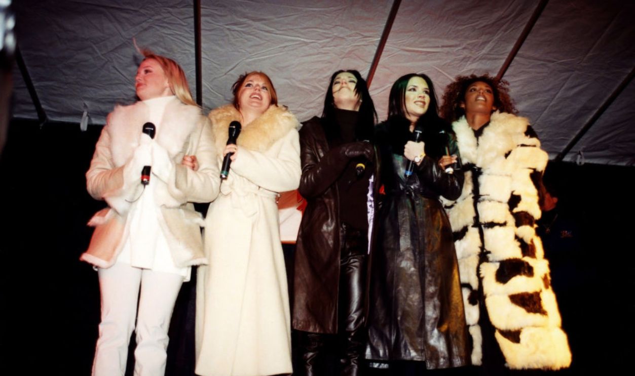 Singers Ginger Spice (Geri Halliwell), Baby Spice (Emma Bunton), Sporty Spice (Melanie Chisholm), Posh Spice (Victoria Adams, later Beckham) and Scary Spice (Melanie Brown) of The Spice Girls chats with fans upon their arrival at Planet Hollywood in Chicago, Illinois in January 1996. 
