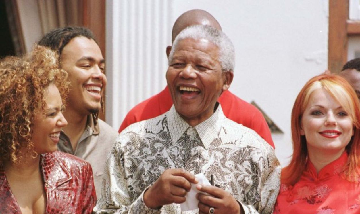 Library file, dated 1/11/97. South Africa's President, Nelson Mandela, is flanked by Spice Girls Mel B (left) and Geri, during a photocall with the Spice Girls at the presidential residence Mahlamba Nalopfu in Pretoria, South Africa: Ginger Spice, Geri Halliwell announced today (Sunday) that she is to leave the group. See PA story SHOWBIZ Spice. Photo by John Stillwell /PA.