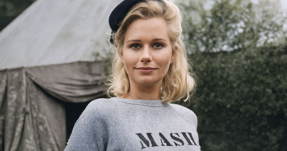 Sally Kellerman wearing a MASH shirt and hat