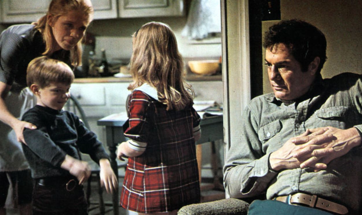 Sally Kellerman talks to the children as Tony Curtis sits down in a scene from the film 'The Boston Strangler', 1968. 