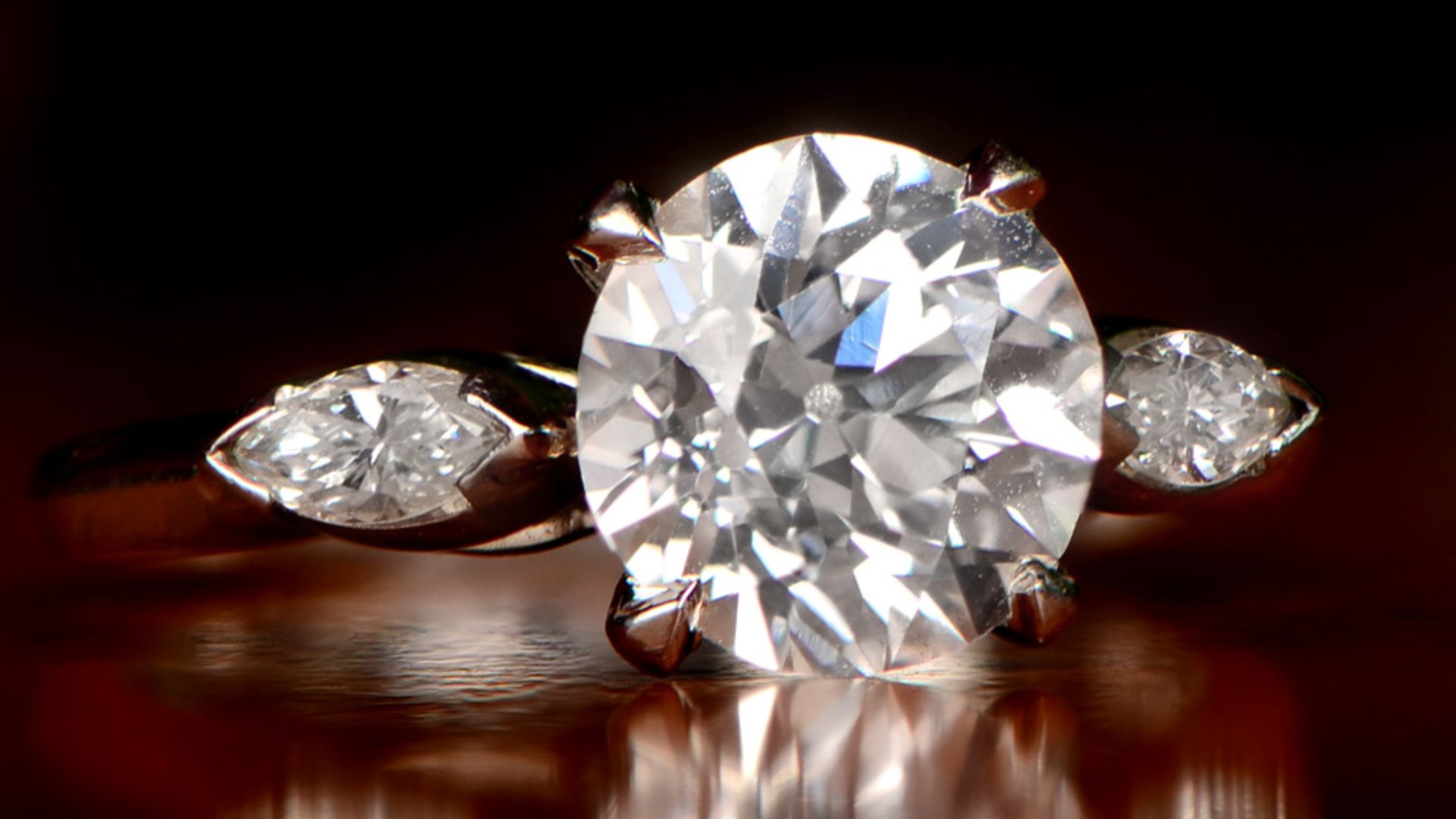 A D color antique diamond, set in handcrafted platinum, and accented by two side diamonds. This ring was handcrafted circa 1920 and is part of the Estate Diamond Jewelry Collection located at https://www.estatediamondjewelry.com