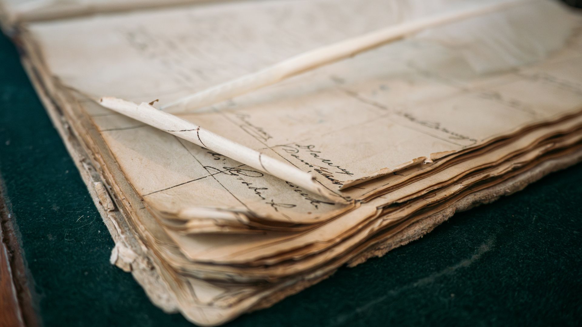 A close-up of an old, open ledger with handwritten notes
