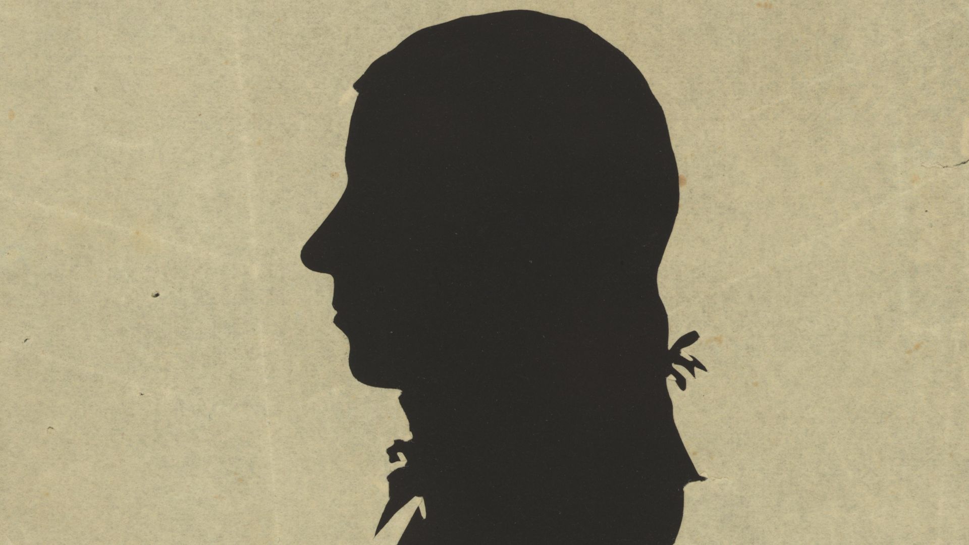 Title: Silhouette of man facing left, no. 10
Abstract/medium: 1 picture : hollow-cut white paper silhouette, mounted on black paper ; irregular image 7 x 4 cm, cut from sheet 12 x 10 cm.