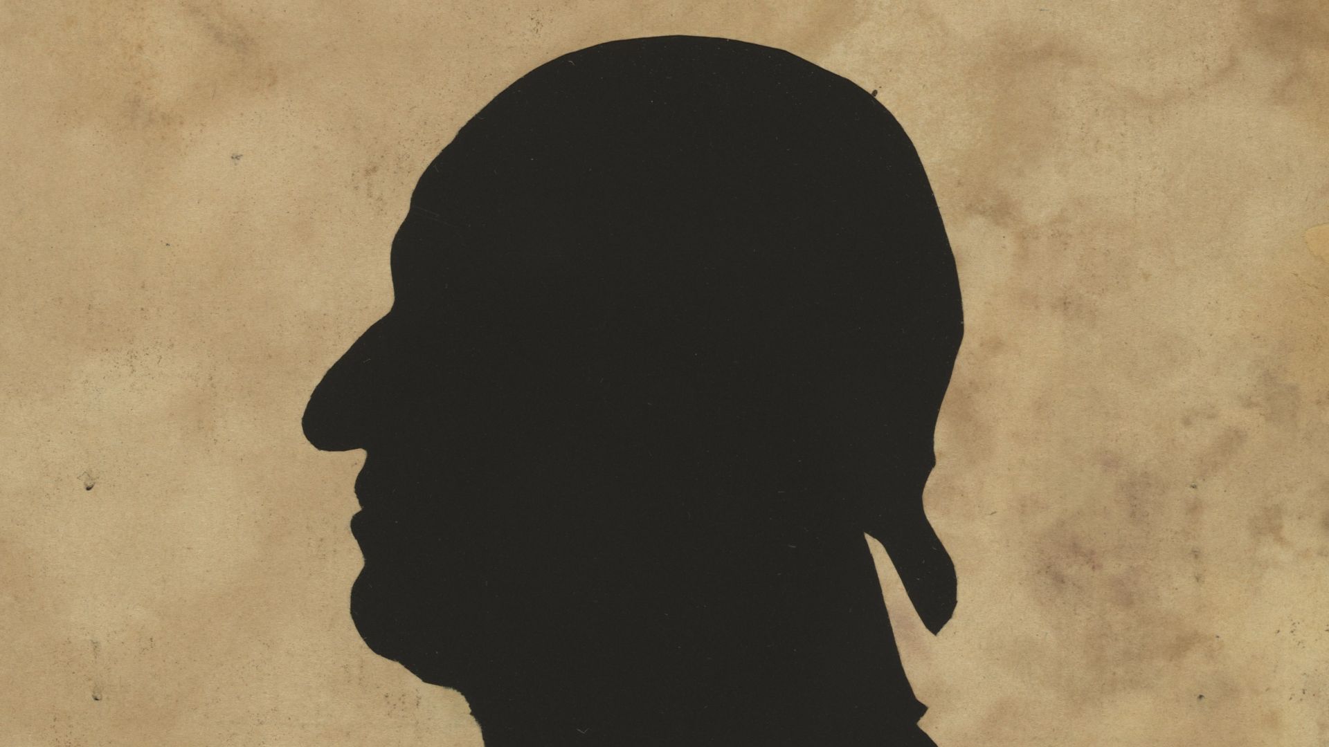 Title: Silhouette of man facing left, no. 8
Abstract/medium: 1 picture : hollow-cut white paper silhouette, mounted on black paper ; irregular image 10 x 6 cm, cut from sheet 15 x 12 cm.