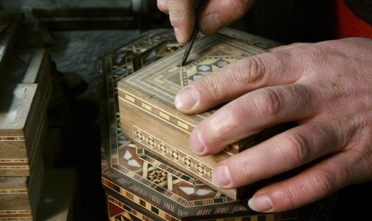 Hands of the Arabian master doing caskets is engaged in work (the city of Damascus, Syria)