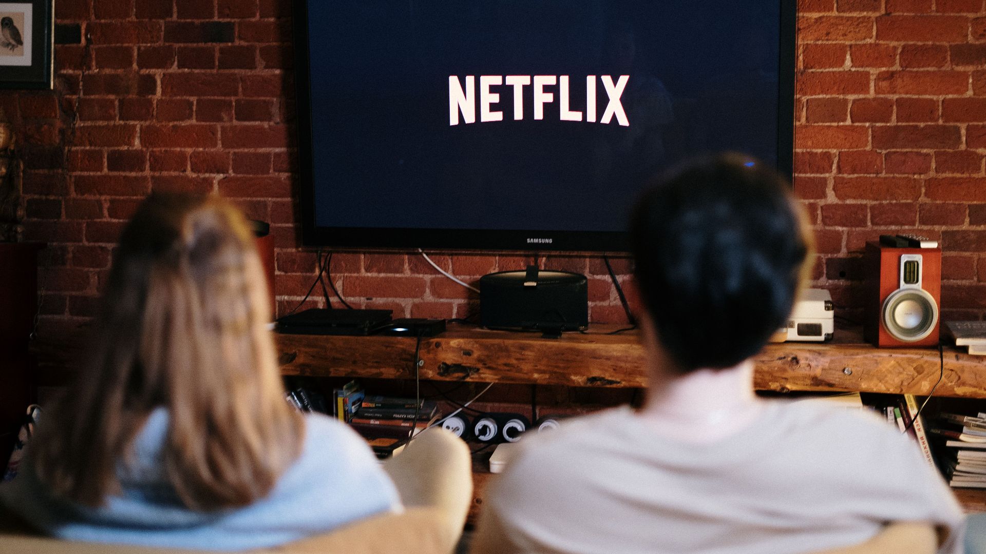 A couple relaxing and watching Netflix in a cozy living room setting.