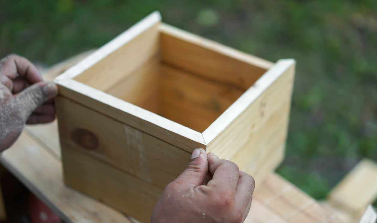 close up wooden square box are created by Asian hand man.
