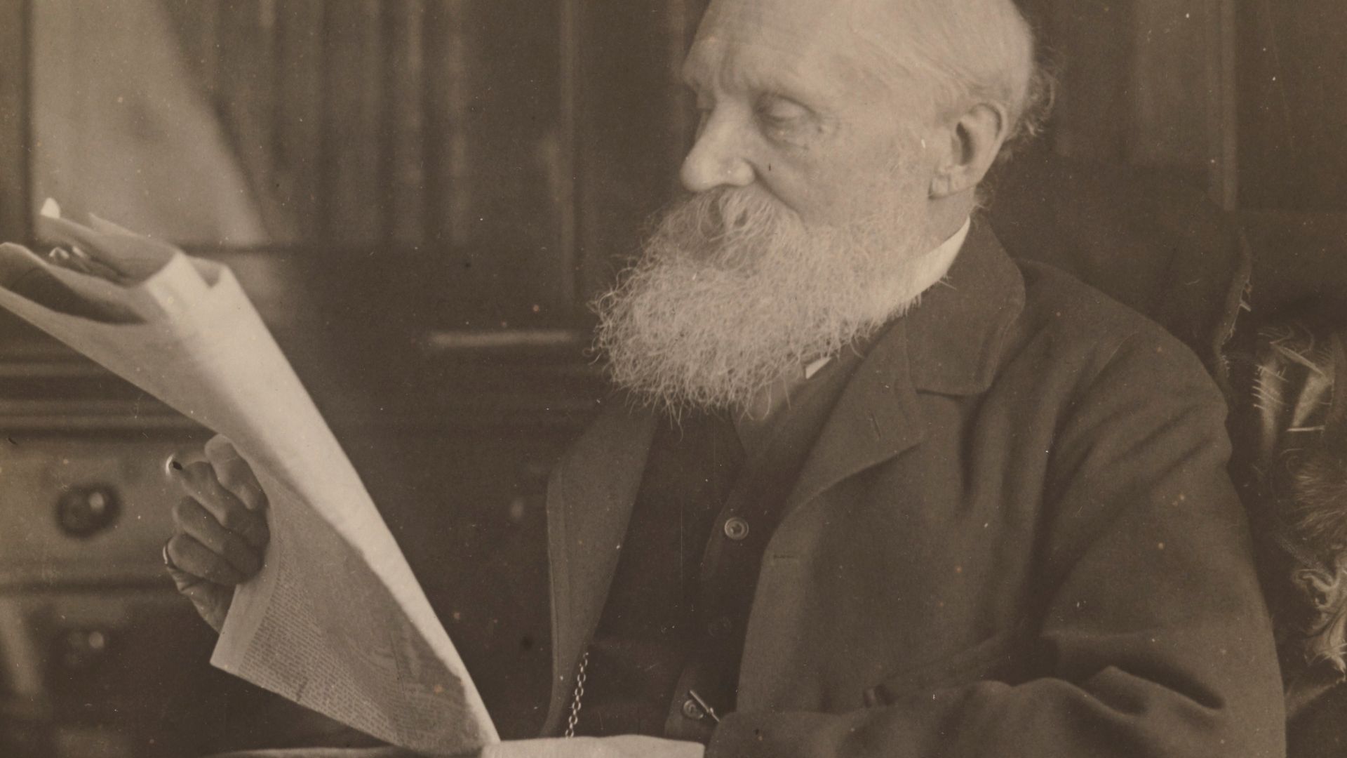 Sir William Thomson Kelvin of Largs, baron from 1896 and British physicist, reading a newspaper.