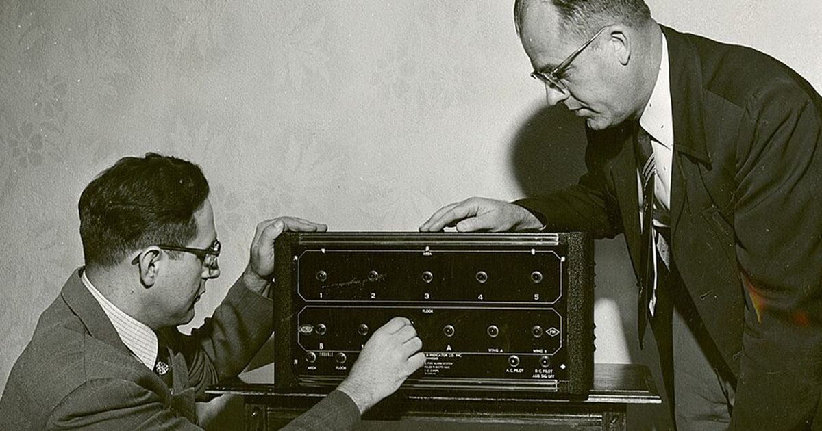 Scientists inspecting fire alarm system