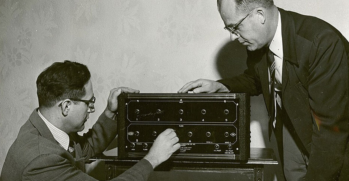 Scientists inspecting fire alarm system