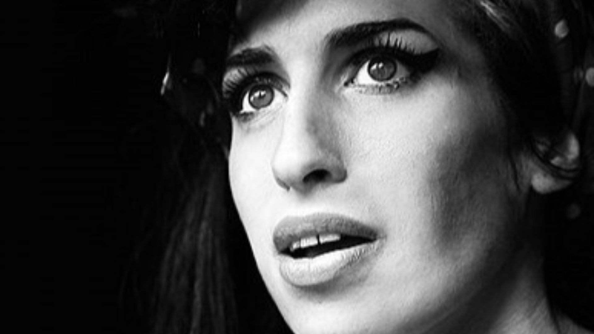 Amy Winehouse opening the door to her flat in Camden. She used to greet all visitors, from autograph hunters to neighbourhood kids.