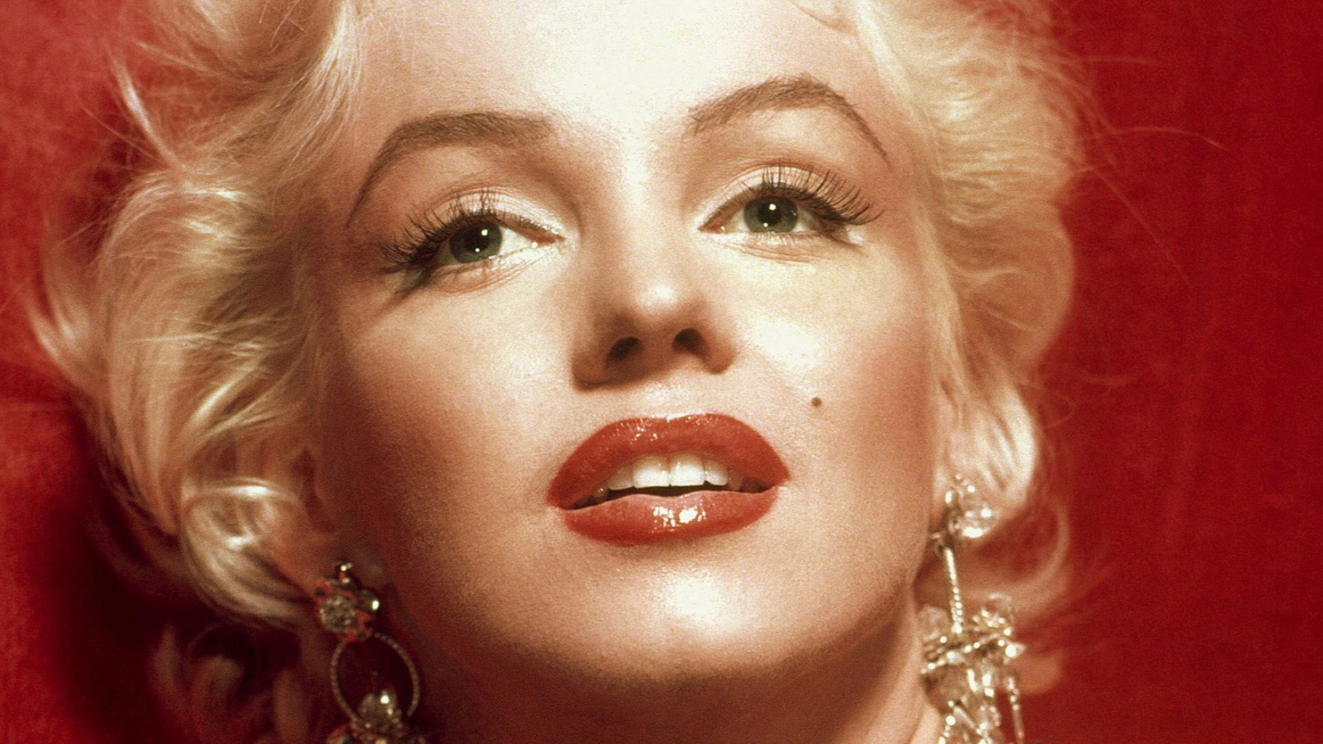 A glamorous Marilyn Monroe in a red dress, taken for publicity purposes for 1953 film How to Marry a Millionaire.