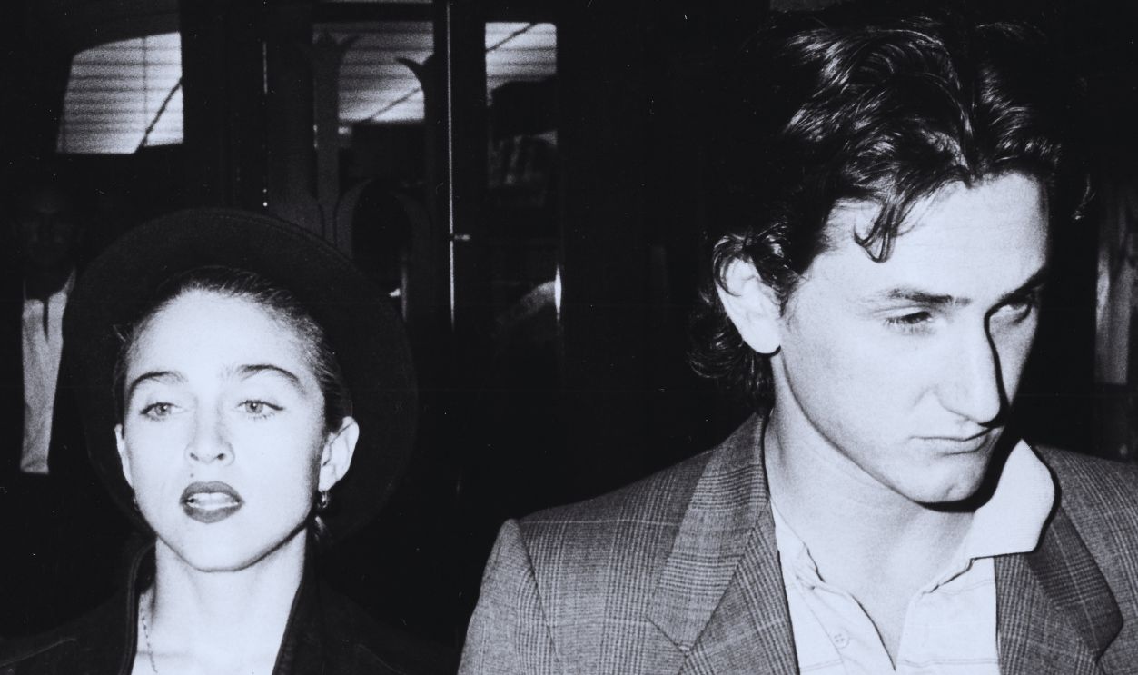 Singer Madonna and her husband, actor Sean Penn, walking along a street together, circa 1988.