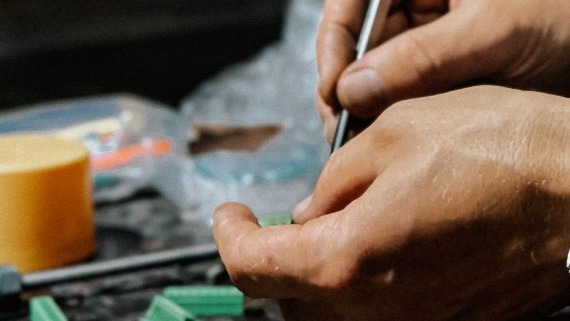 A skilled technician carefully repairs electronic components on a workbench.