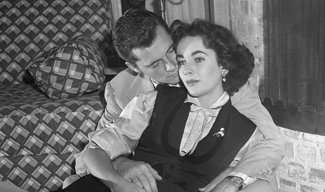 (Original Caption) 1950-Brentwood, CA- THE HILTONS 'AT HOME.' After a ten-hour long day of running the hotel, Nick Hilton relaxes with his movie star wife at their temporary home in Brentwood, CA.
