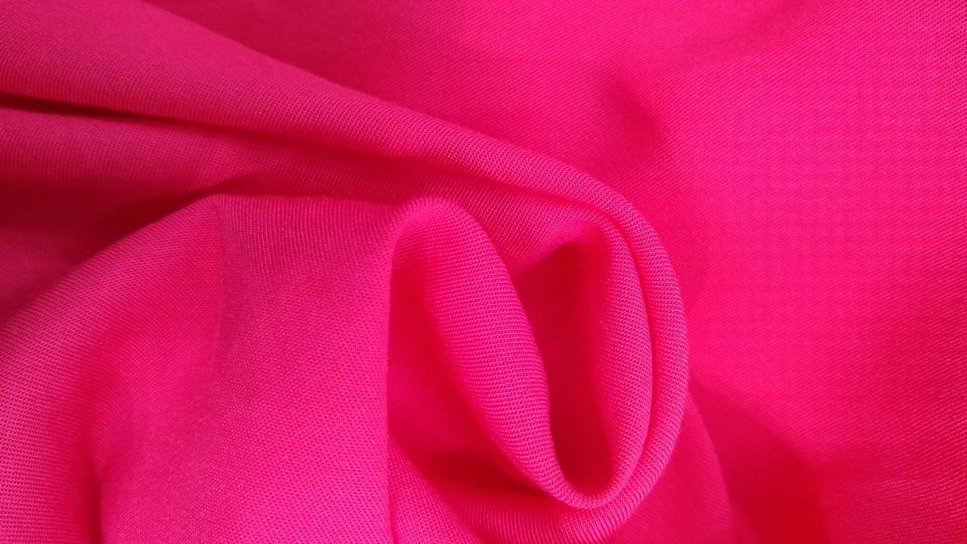close-up of pink rayon challis fabric in a swirl to show drape