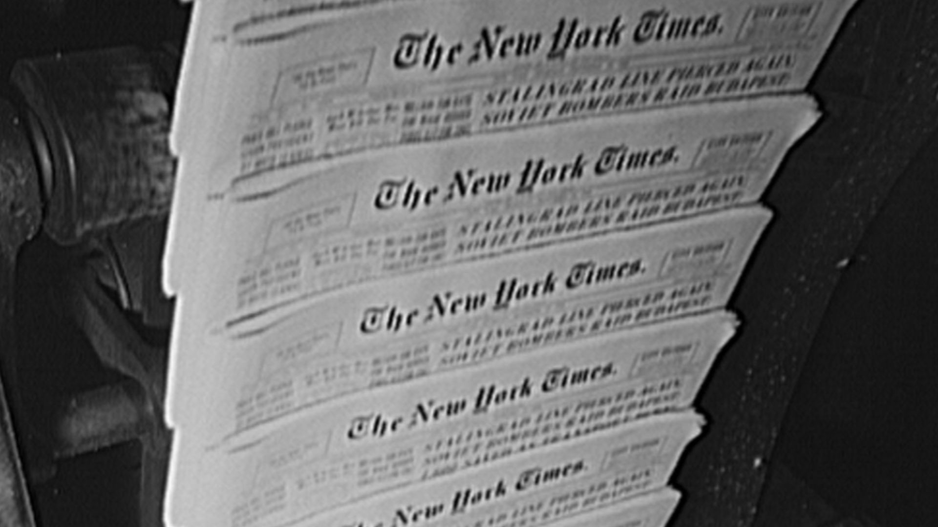 New York, New York. Pressroom of the New York Times newspaper. Finished papers come out of cutting and folding machines on rapidly moving belt. Every fiftieth is automatically slanted to facilitate counting
