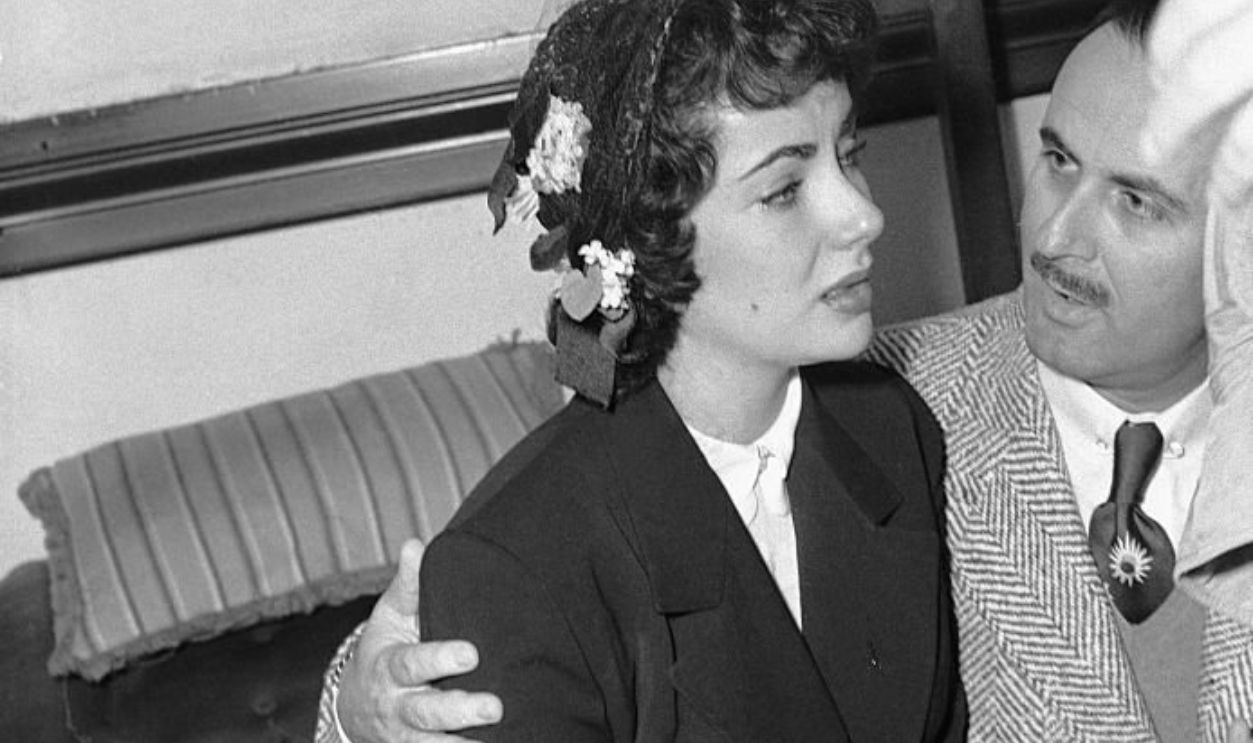 (Original Caption) 1/29/1951-Los Angeles, CA- Actress, Elizabeth Taylor is comforted by studio representative William Lyons as she cries in a Los Angeles court following her divorce from wealthy Nicky Hilton. The beautiful 18-year-old star wound up her 205-day marriage by telling the judge that her handsome bridegroom swore at her. She added that most of the time the 24-year-old Hilton ignored her completely.