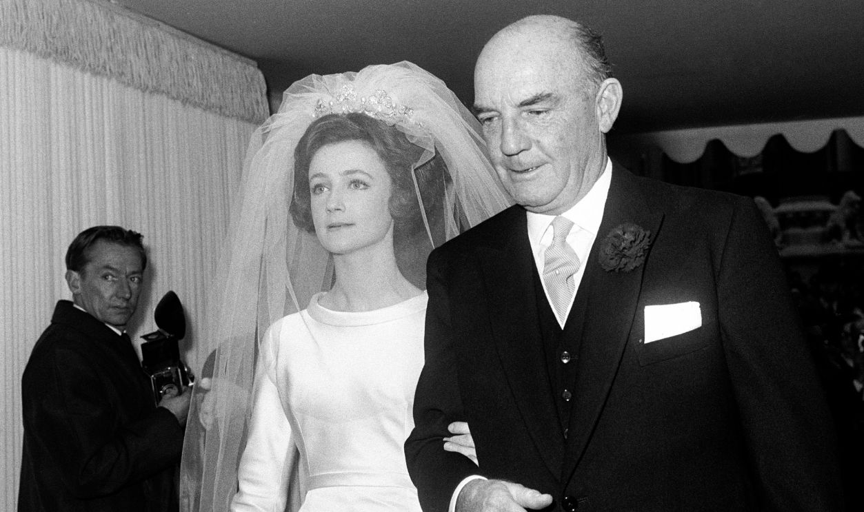 Miss Lindy Guiness, 22, pictured with her Father, Mr Loel Guinness, the financier, on arrival at Westminster Abbey