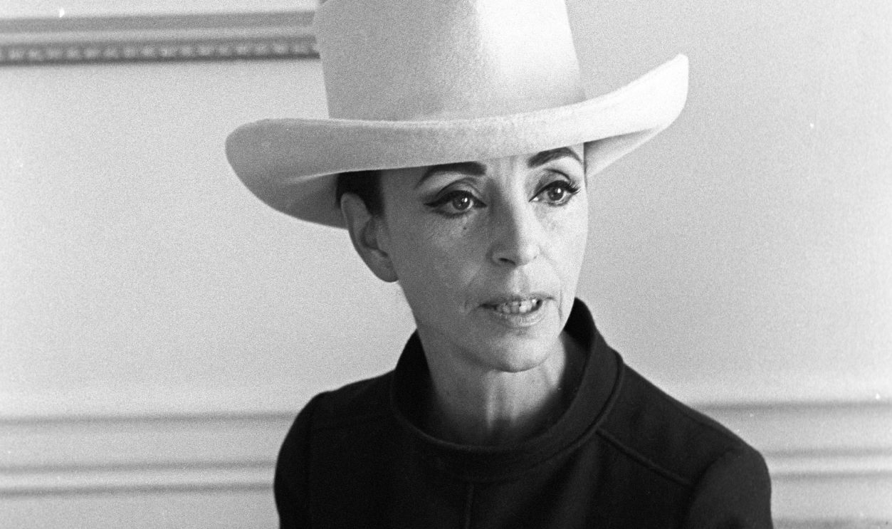 Socialite Gloria Guinness smoking prior to accepting the J.C. Penny award as the 