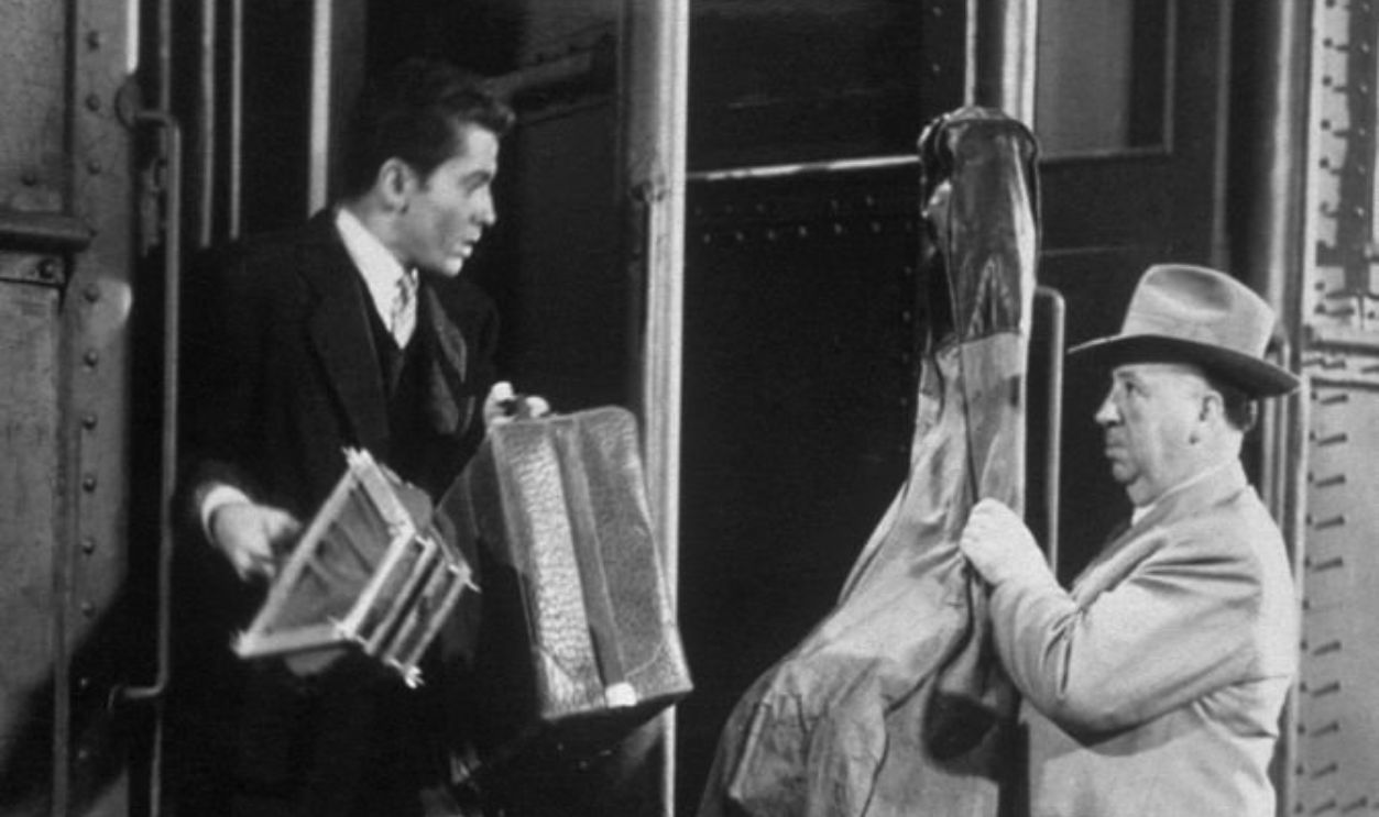 (Original Caption) Farley Granger and Alfred Hitchcock on location for 'Strangers on a train'. 