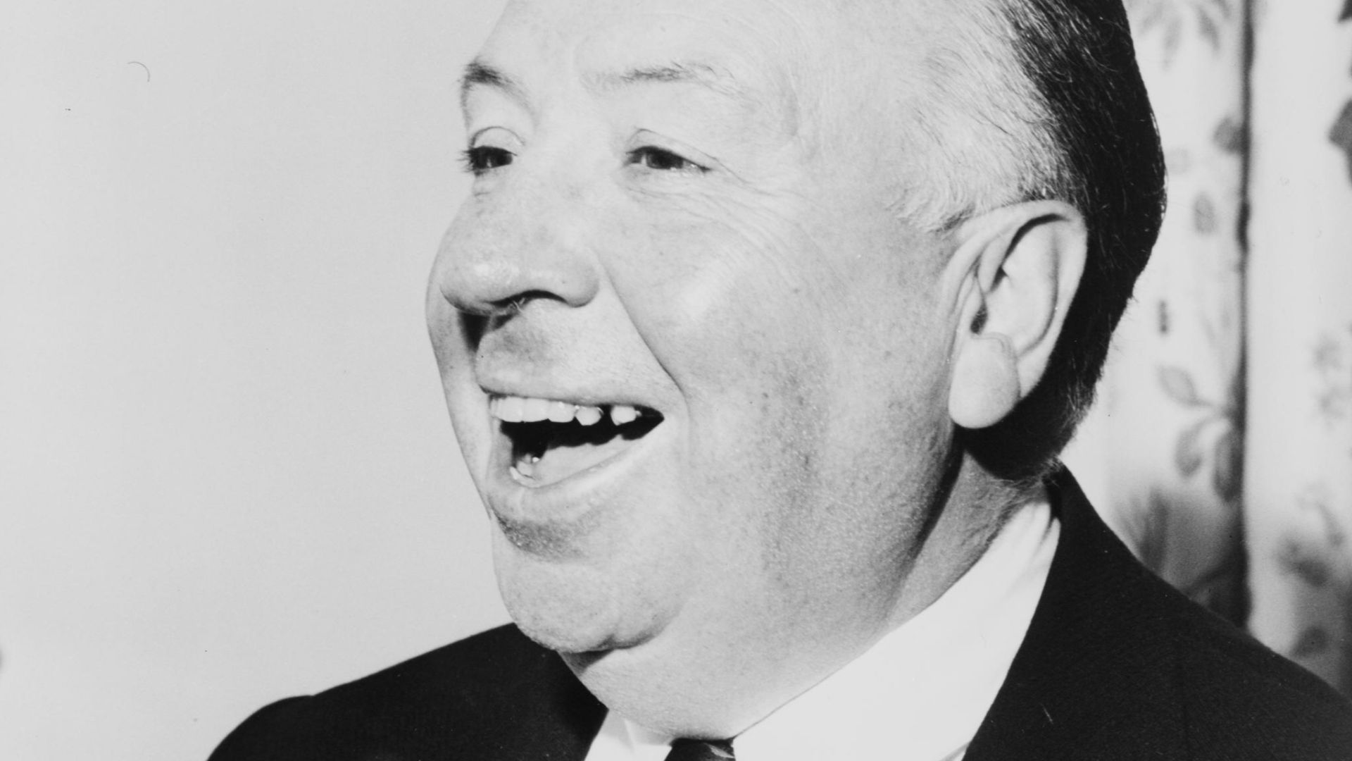 Alfred Hitchcock, head-and-shoulders portrait, facing left