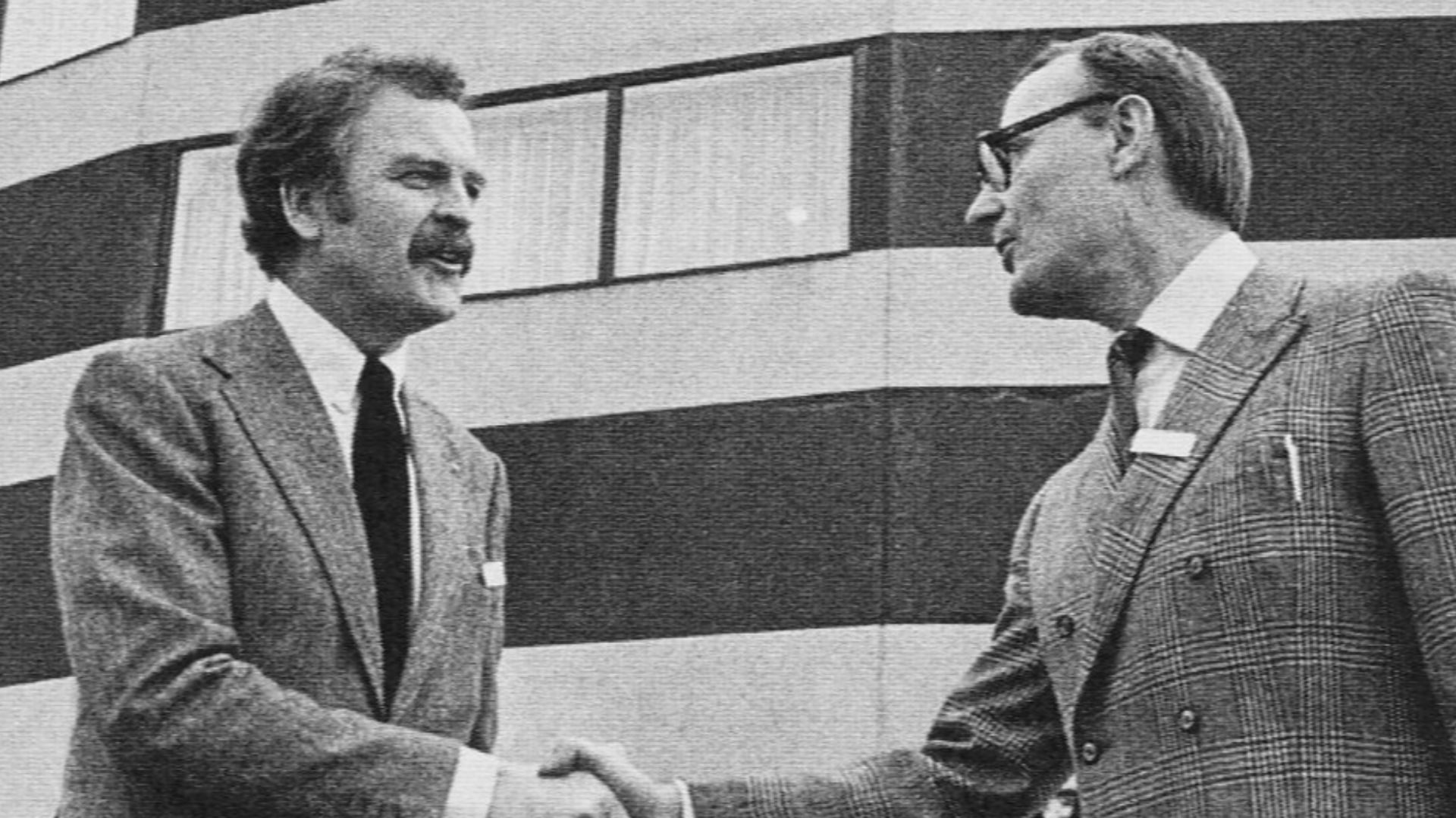 Hans Ax (left),  IKEA's first store manager, shakes hands with IKEA founder Ingvar Kamprad