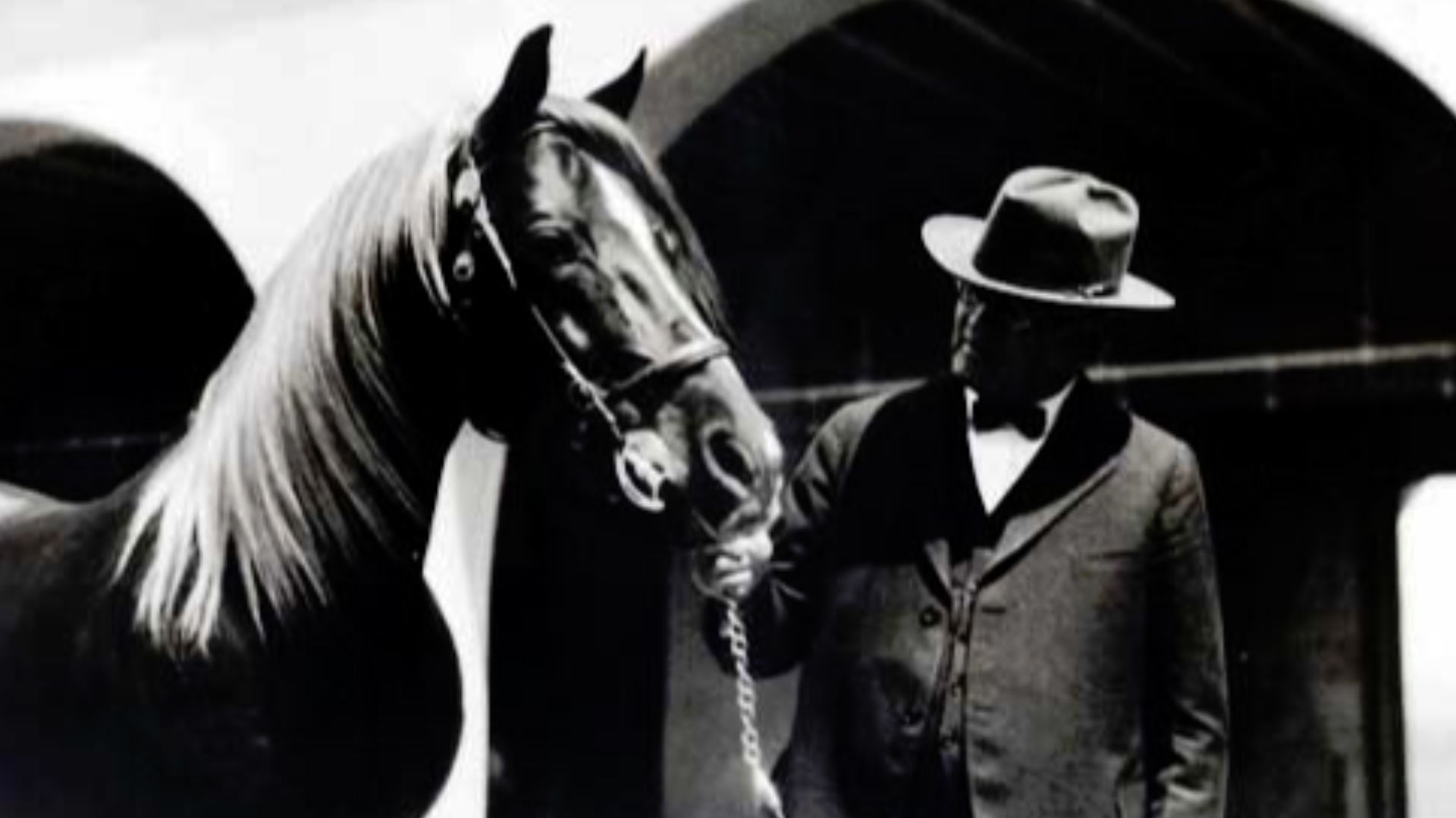 Will Keith Kellogg and Antez, an Arabian horse and allegedly one of his favorite horses, with the horse stables (currently the University Plaza building at California State Polytechnic University in the background). According to the Cal Poly Pomona Univer