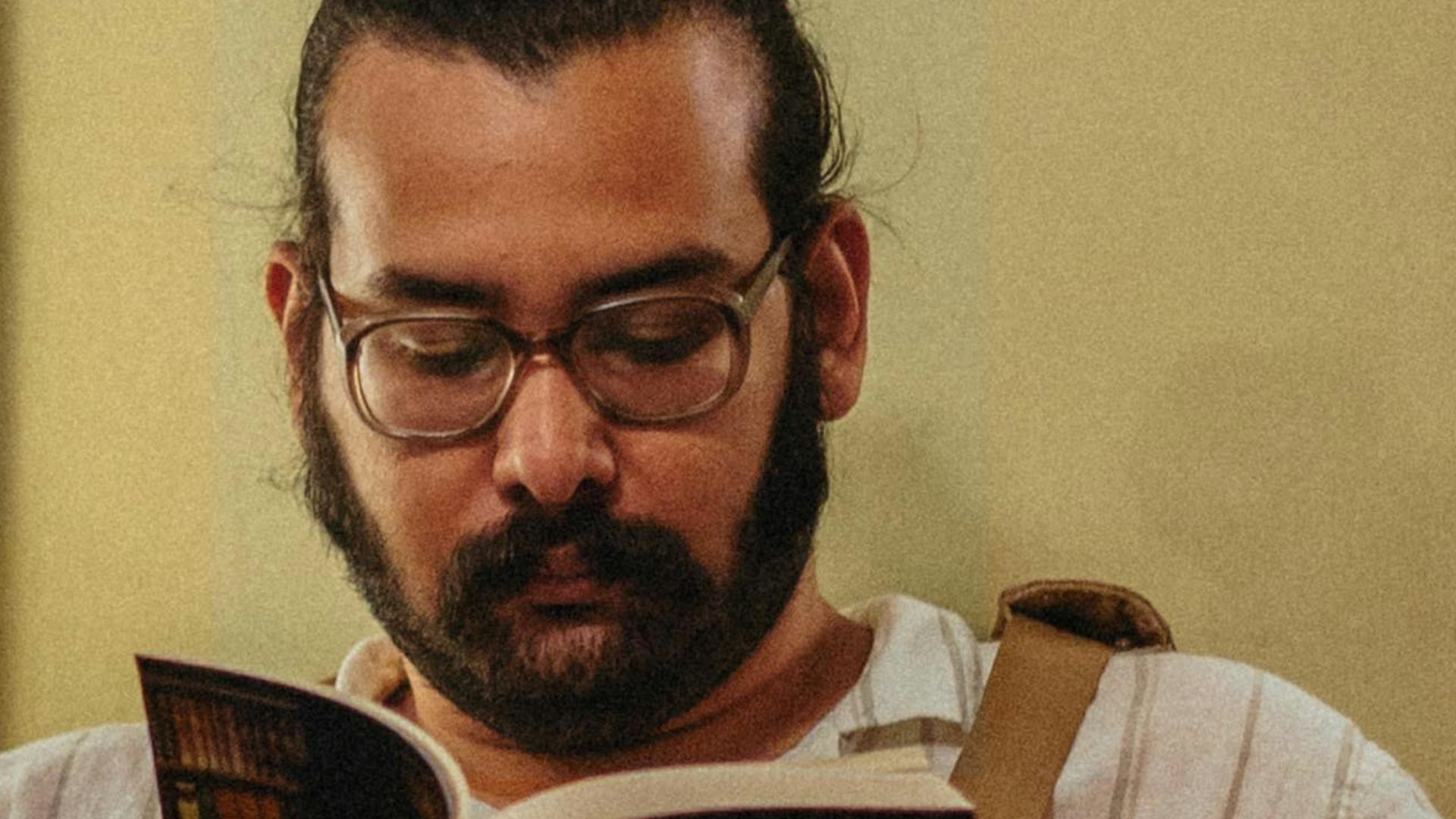 a man sitting in a chair reading a book