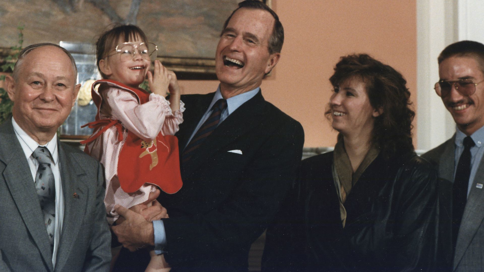 President Bush holds Jessica McClure during the Midland Community Spirit Award Presentation in the Roosevelt Room at the White House. The award was established by the town of Midland, TX and awarded to Sioux City, IA in recognition of the community's resp