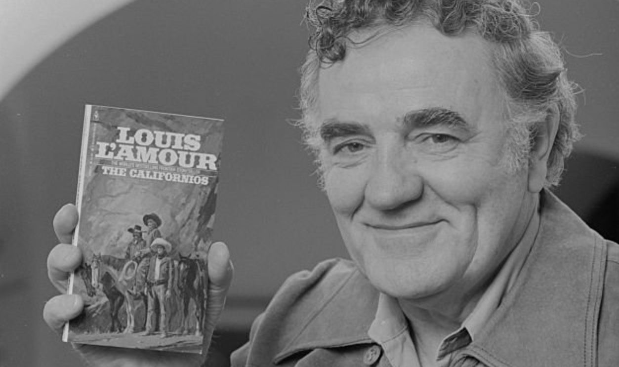 70's top-selling Western novelist Louis L'Amour holds up his book The Californians at his home in California.