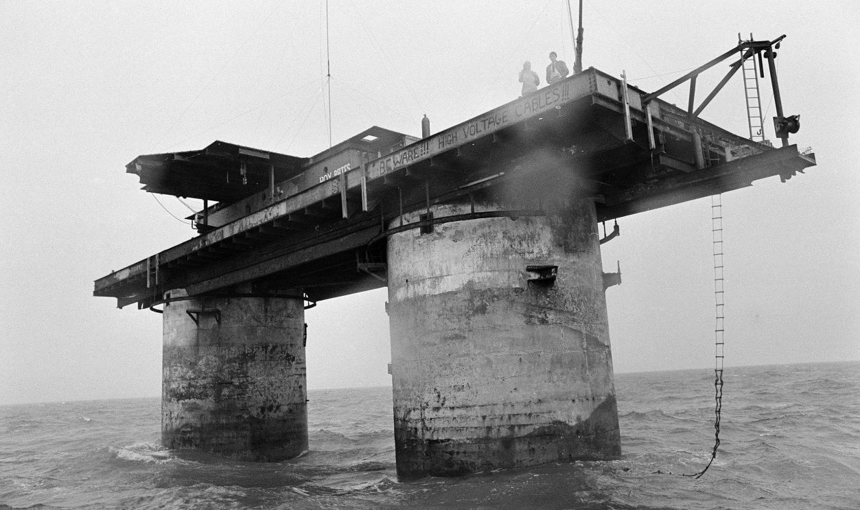The Principality of Sealand, Roughs Tower, a wartime man-made Maunsell Sea Fort situated seven miles off the coast of Harwich, Essex, Friday 25th October 1968. Our picture shows Joan Bates, Princess Joan of Sealand and son Michael aged 16 looking out from the platform. Almost two years ago, the Bates family took over the former British naval defence platform and ever since, have been taking shifts in guarding it against invaders. Last week, a British judge ruled that the tower was outside British legal jurisdiction, which means that the Bates family have sovereignty over their island fort