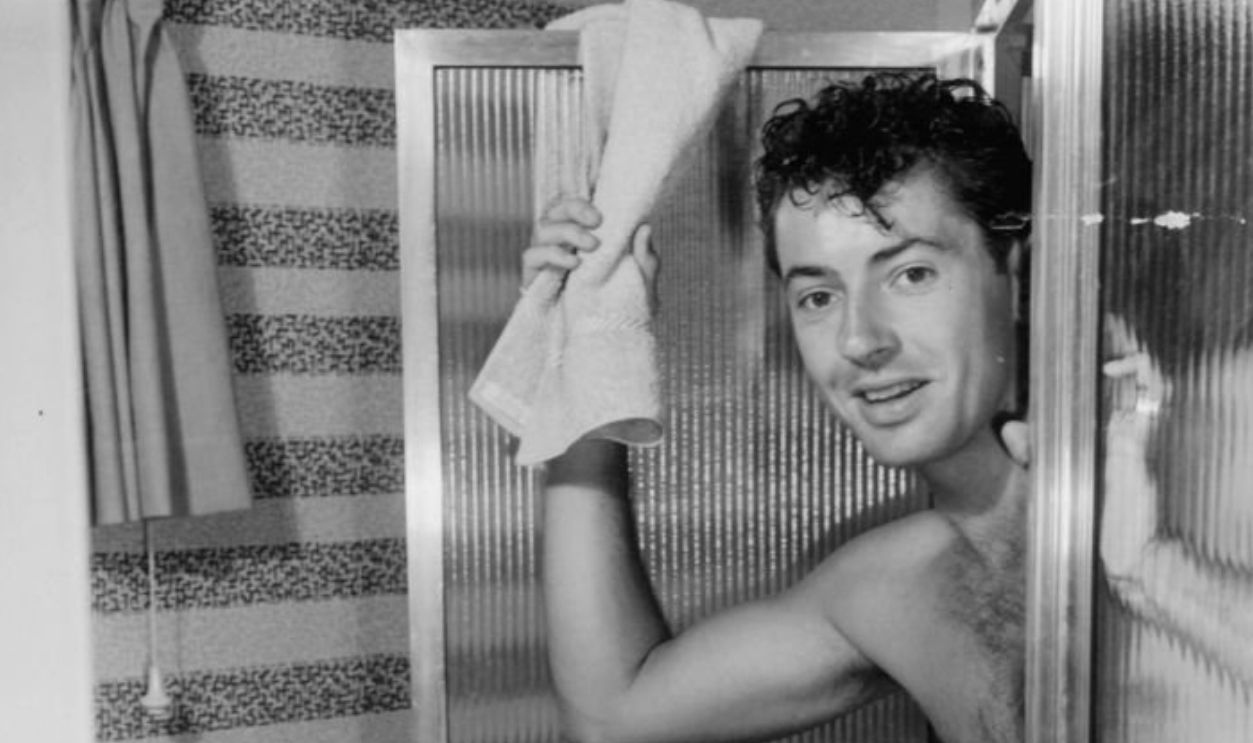 Farley Granger opening shower door in a scene from the film 'Our Very Own', 1950.