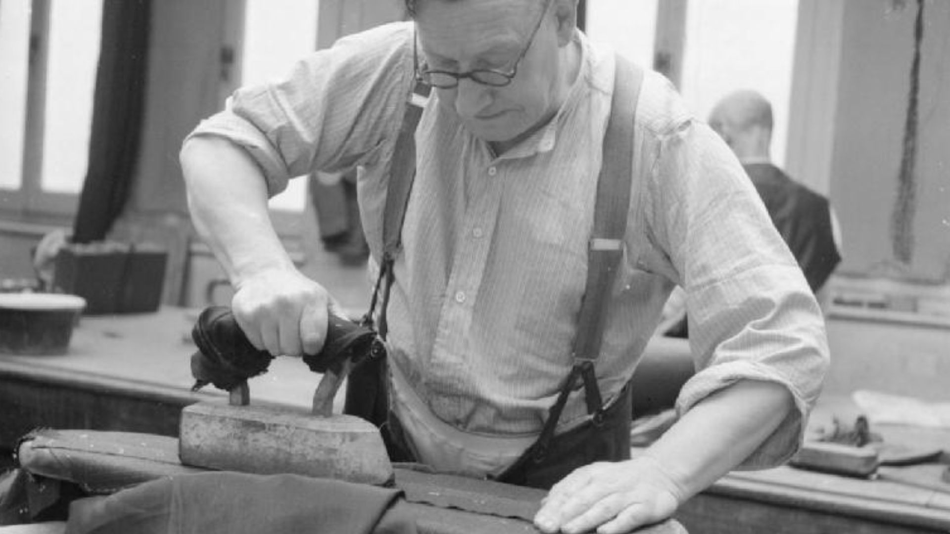 Savile Row- Tailoring at Henry Poole and Co., London, England, UK, 1944
A tailor uses his 'goose' (a heavy iron) to press the seams of a jacket in the workroom of Henry Poole and Co. on Savile Row in London.