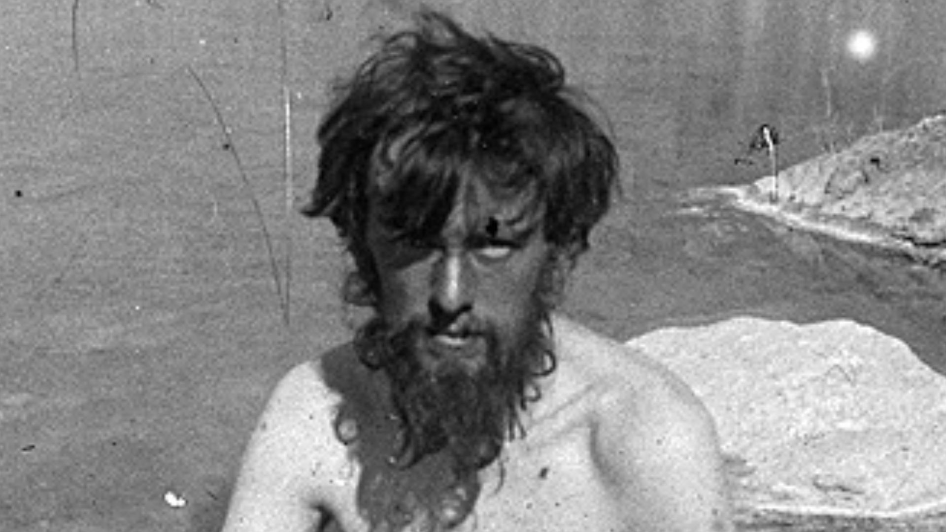 The English occultist, poet, and novelist Aleister Crowley bathing in a spring on the lower Baltoro Glacier during his 1902 expedition to climb K2 in the Himalayas.