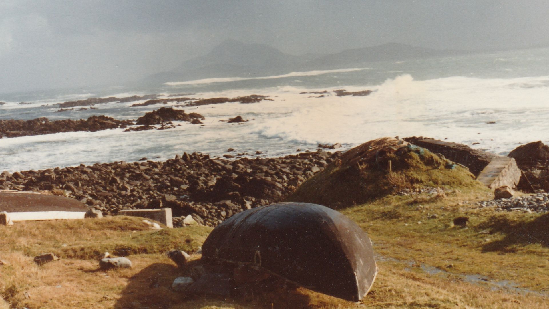 near Kill pier, Clare Island, Co Mayo. Upturned currach. Date is approximate but correct month. Looking towards Croagh Patrick mountain