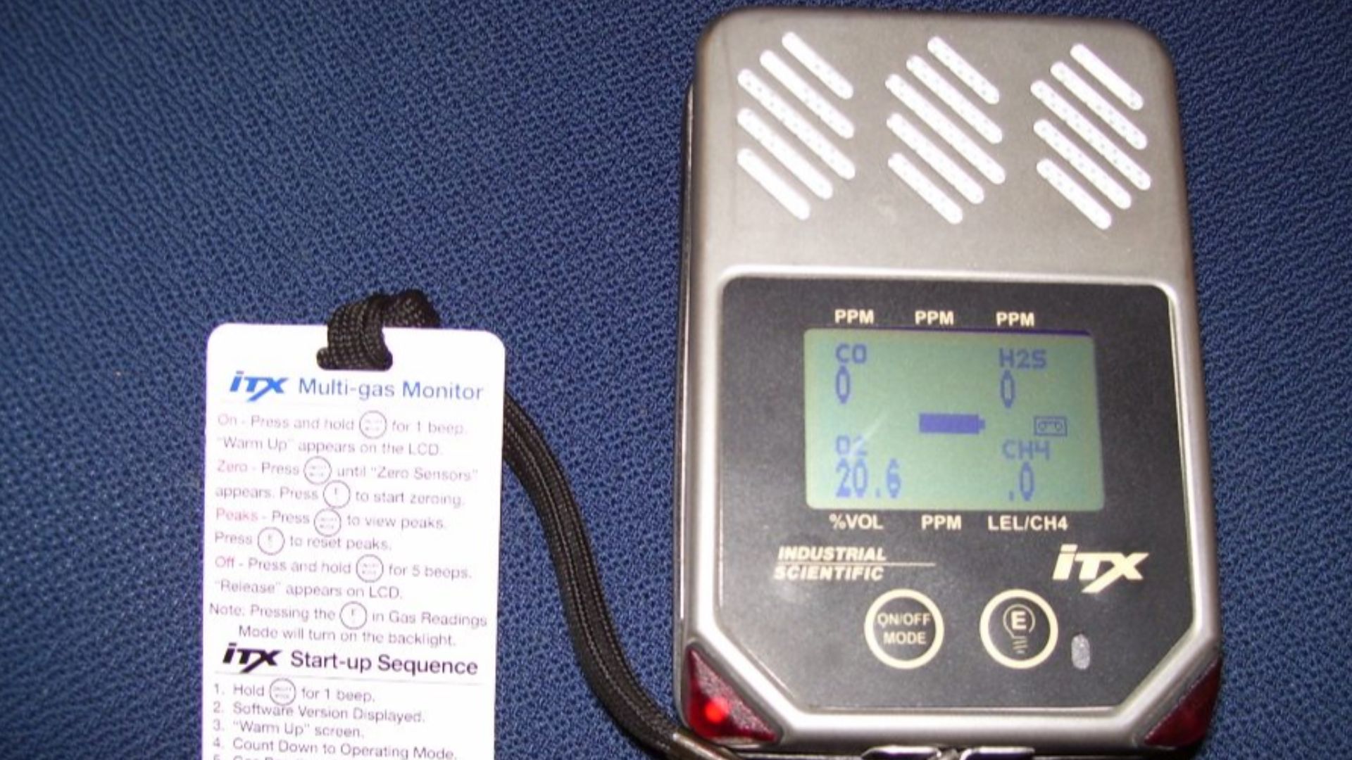 Portable gas detector (or monitor) from Industrial Scientific company, ITX model (2006). Detectable gases include oxygen, hydrogen sulfide, carbon monoxide and methane (LEL - lower explosive limit). Card attached gives summary instructions for its use.